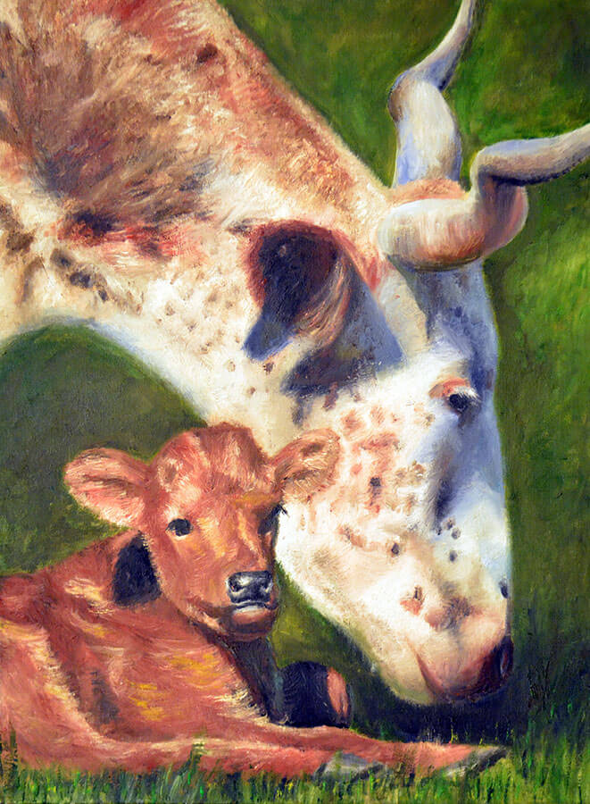 Close-up of a mother cow eating grass besides her baby
