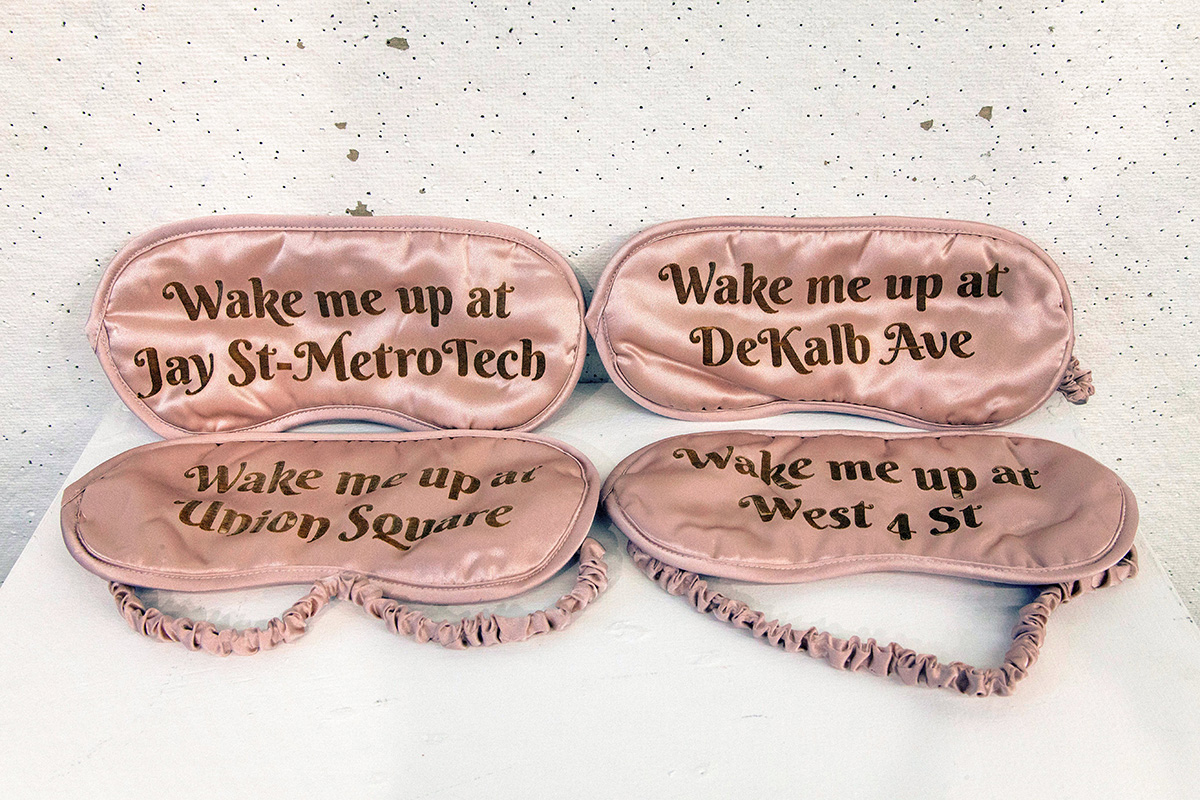 Four sleeping masks with different subway stops printed on them